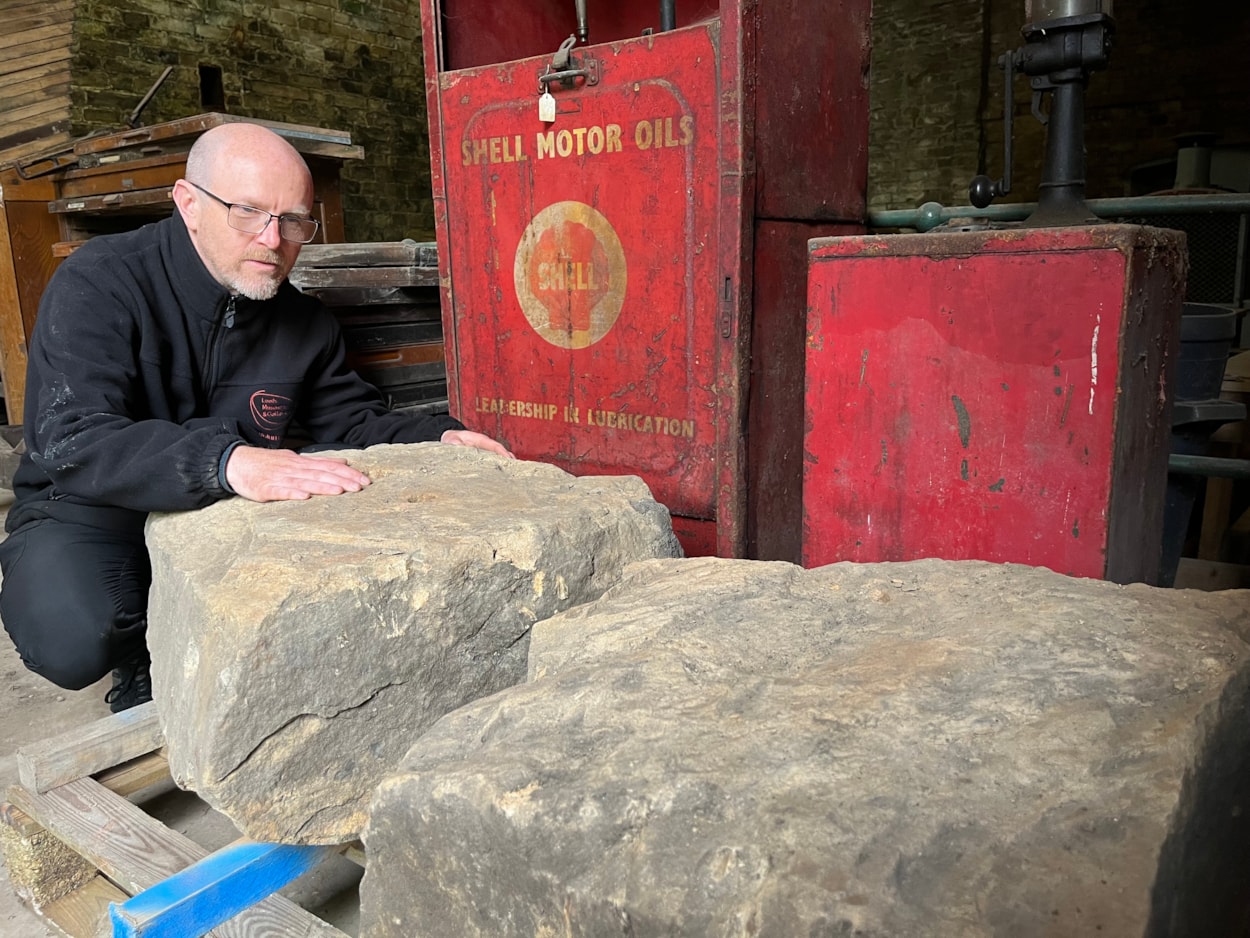 Train station excavation: John McGoldrick, Leeds Museums and Galleries’ curator of industrial history with a pair of huge stone sleepers, used to secure tracks at the Marsh Lane railway station in the years before wooden sleepers were employed. The sleepers still show the holes where railway spikes were driven into them.