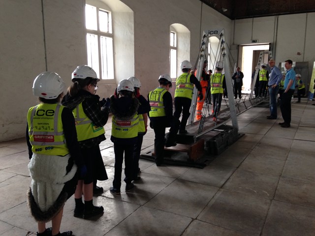 Newport school children testing their bridge at Tredegar House