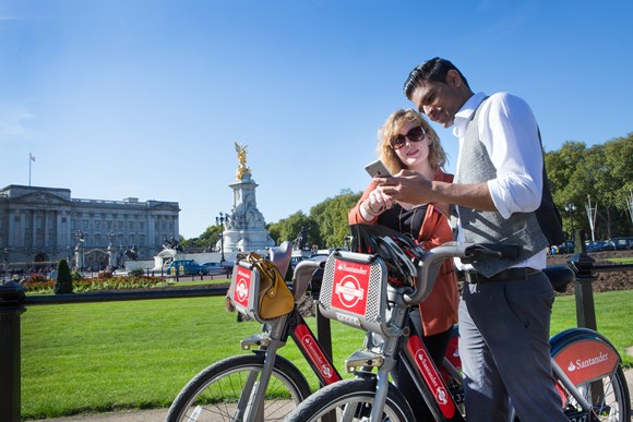 Two cyclists using the Santander Cycles app