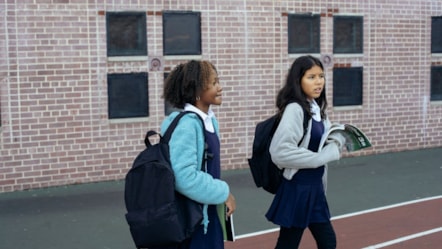 Two girls walking to school