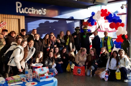 A crowd gathered by the balloon arch
