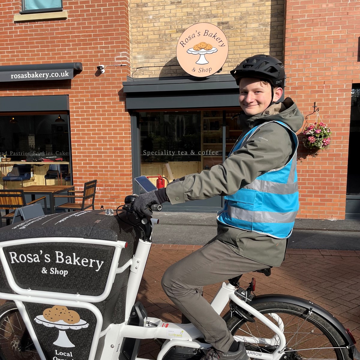 Ruben at Rosa's Bakery delivering baked goods on his e-bike. Rosa's Bakery can be found on Instagram at rosasbakery.co.uk