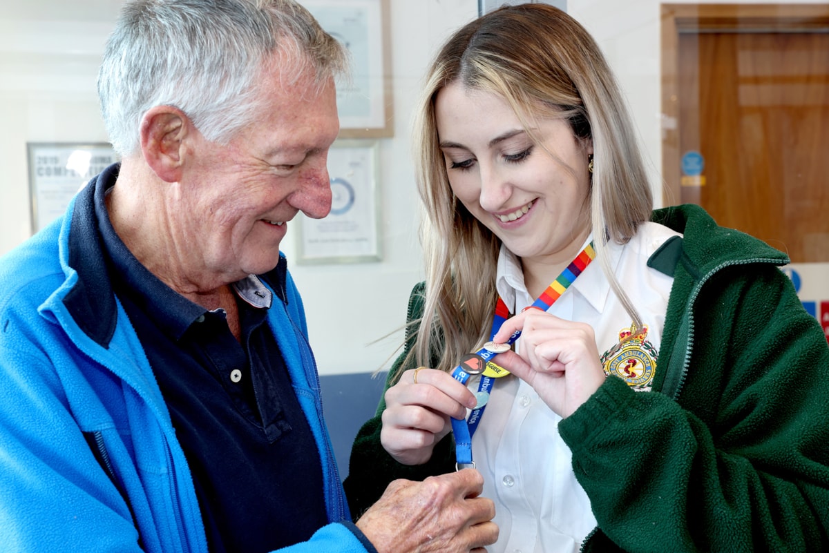 NEAS health advisor Charlotte Saul shows Chris Browitt the pin badge she earned for saving his life