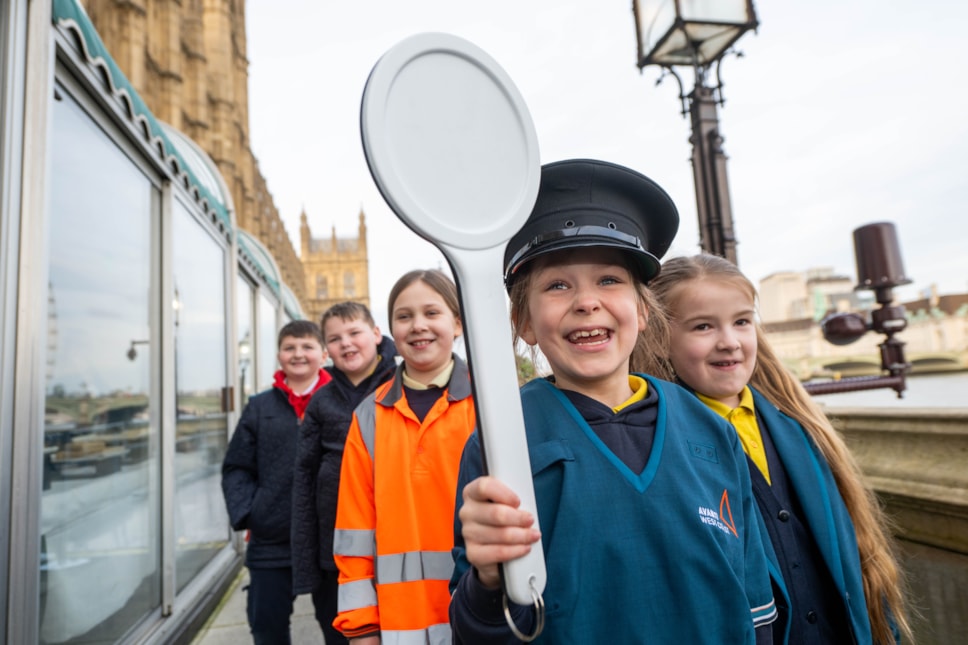 School pupils dress up in railway uniform at Avanti West Coast's celebration event in Parliament to mark the completion of its Feel Good Field Trips initiative.