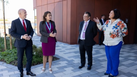 Two men and two women stood outside the entrance of the University of Cumbria Barrow campus