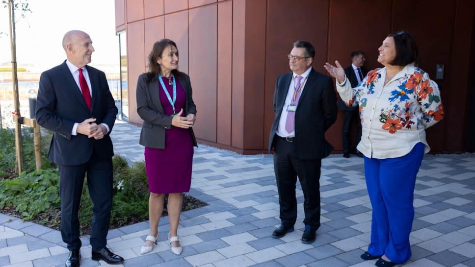 Two men and two women stood outside the entrance of the University of Cumbria Barrow campus