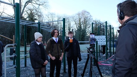 Maija Jones, Isaac Swanson, and Luke Hall are being interviewed by a journalist at the opening of the Forres Outdoor Gym.