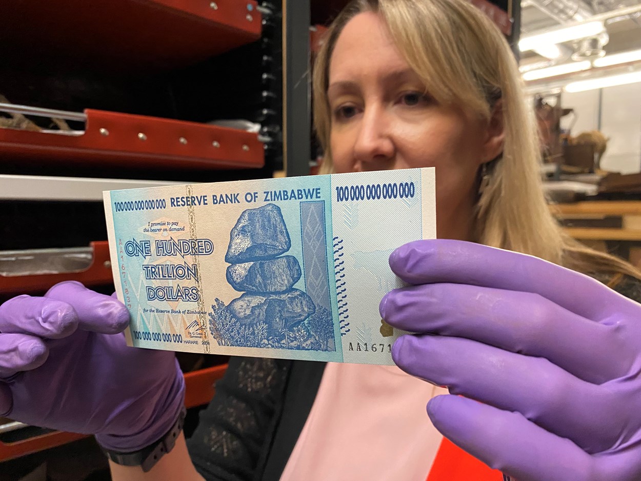 Money Talks: Kat Baxter, Leeds Museums and Galleries’ curator of archaeology and numismatics with a one hundred trillion dollar bill issued by the Reserve Bank of Zimbabwe in 2008 during a period of hyperinflation.