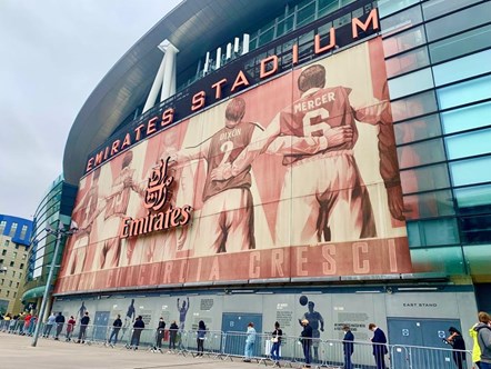 People arrive at the Emirates Stadium mass vaccination centre to receive their Covid-19 jabs