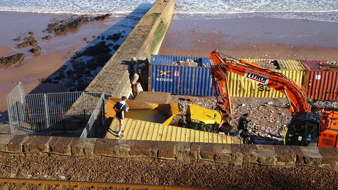 Individuals pictured ignoring the safety fencing and entering the working construction site at Dawlish.