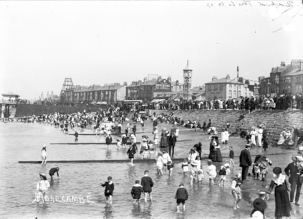 The clock tower, a gift to the town of Morecambe in 1905 by Councillor John Robert Birkett, who was Mayor of Morecambe nine times. The skeleton of Morecambe Tower is on the left, which was was removed around the time of the Great War,  with only the complex around the base surviving until 1961.  On 