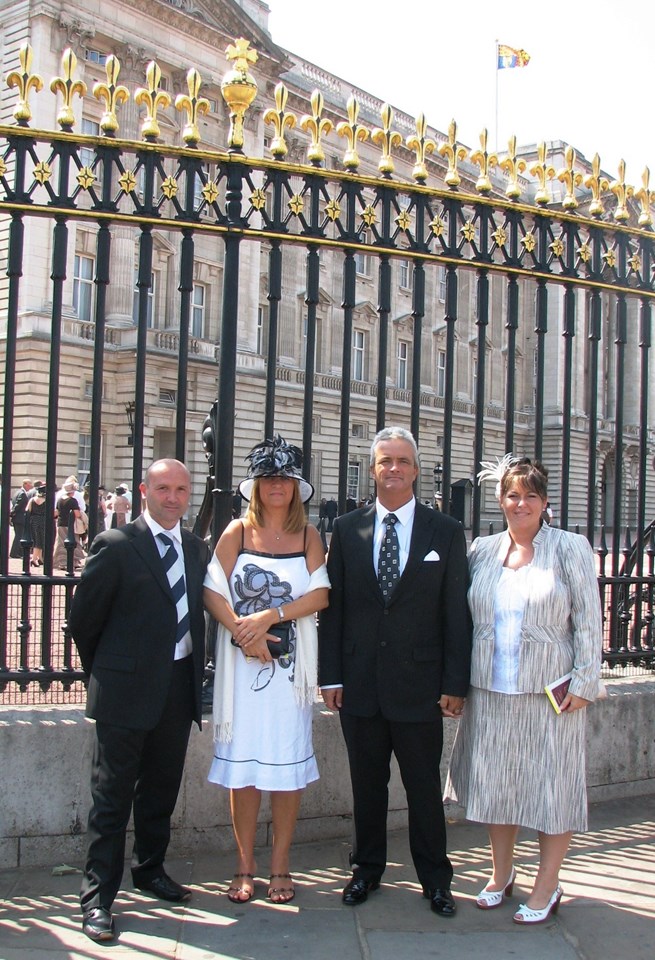 King's Cross Staff honoured at Buckingham Palace for 7/7 efforts: King's Cross Station Manager Peter Armstrong-Cribb (left) and Duty Station Manager Paul Chippington (right centre) with partners outside Buckingham Palace where they were honoured for their efforts during the 7/7 tragedy last year.