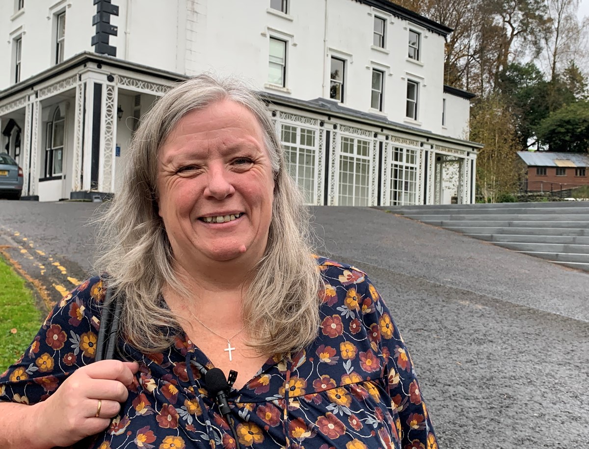 Ambleside alumnus Cathy Styles stood in front of Scale How on the University of Cumbria campus, attending the alumni open day on 28 October 2023