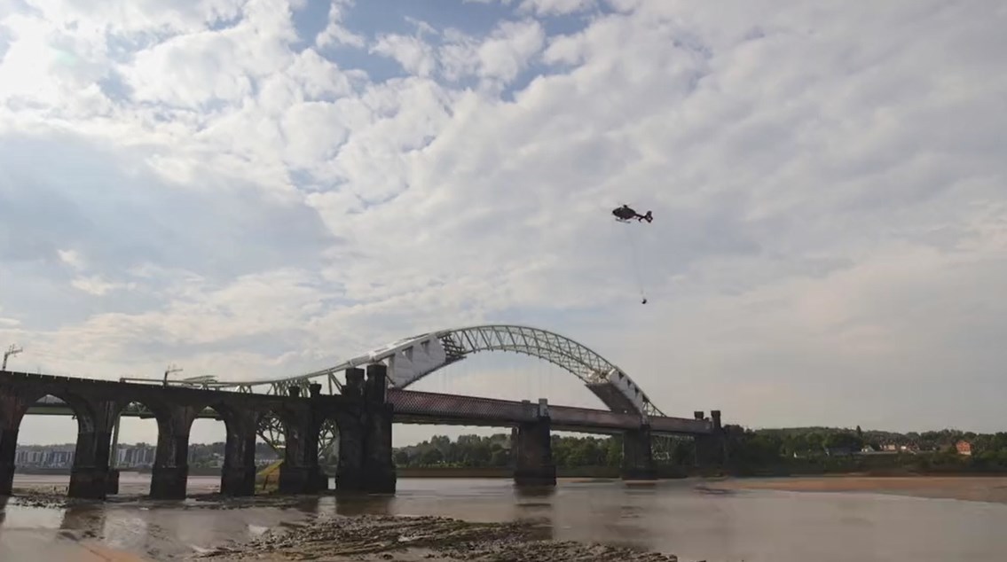 Historic navigation bell restored to celebrate iconic viaduct’s 150th birthday: Runcorn Viaduct bell being removed by helicopter