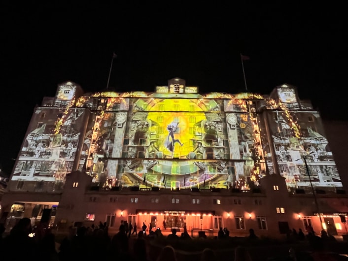 Light Night 2024: At The Queens Hotel The BookBinder saw a fairy tale figure lead a cast of birds, beasts and boats, in an impressive projection across the iconic hotel’s façade.
A collaboration with the British Library and created by artists Illuminos,  the piece is inspired by British Library’s Flickr Commons collection which includes fantastical drawings, prints and images.