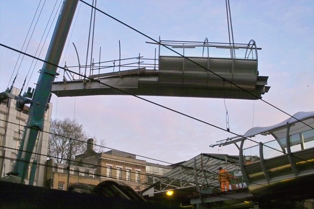 Thameslink - Farringdon footbridge 2: The final section of the new steel and glass footbridge at Farringdon station is lifted into place.