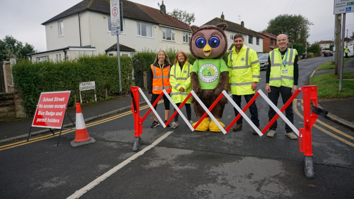 Leeds City Council safe and sustainable travel team with Arlo the Owl, the council's safe and sustainable travel mascot on Ireland Wood's new School Street: Image shows Leeds City Council staff stood next to Arlo the Owl, a safe and sustainable travel mascot.