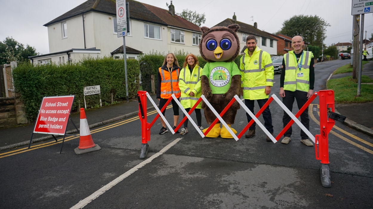 Leeds City Council safe and sustainable travel team with Arlo the Owl, the council's safe and sustainable travel mascot on Ireland Wood's new School Street: Leeds City Council's safe and sustainable travel team with Arlo the Owl, the council's safe and sustainable travel mascot on Ireland Wood's new School Street