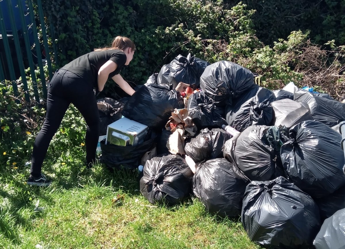 A member of the Recycling & Enforcement Team investigating a fly-tipping incident in Reading