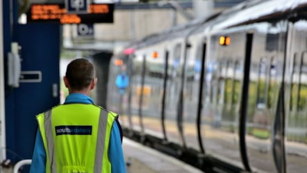 Stock image of a train and a Southeastern employee