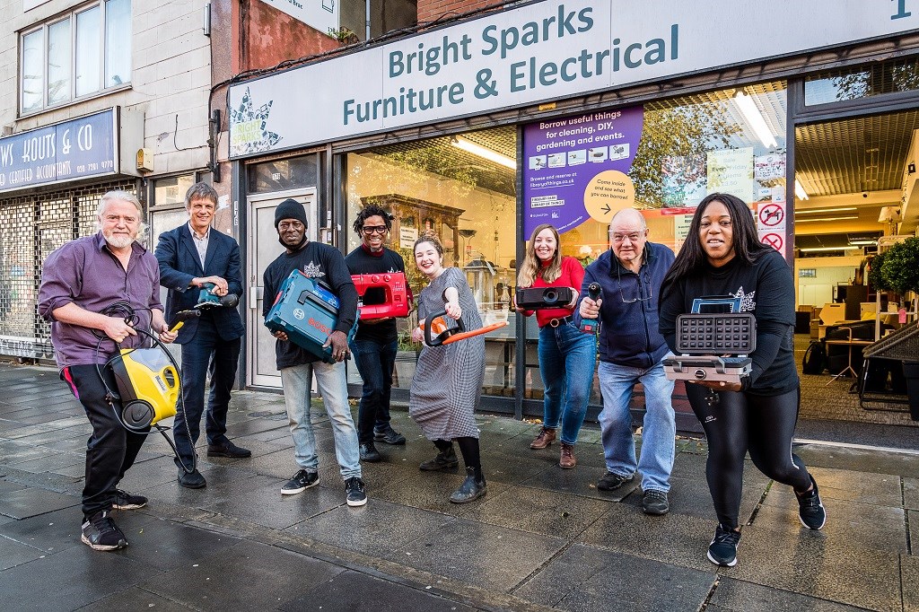 Islington's Library of Things store offers people and businesses the opportunity to borrow household items: From left to right: Joe Duggan (Community Lead, Library of Things); Matthew Homer (Islington Council's Waste Strategy Manager); Mel (Bright Sparks Retail and Customer Service); Diye Wariebi (CEO of Bright Sparks Reuse Project); Essy Sparrow (Community Activator at Library of Things); Emma Shaw (Co-Founder of Library of Things); Cllr Gary Heather (Finsbury Park ward councillor); Dionne (Bright Spars Retail and Customer Service)