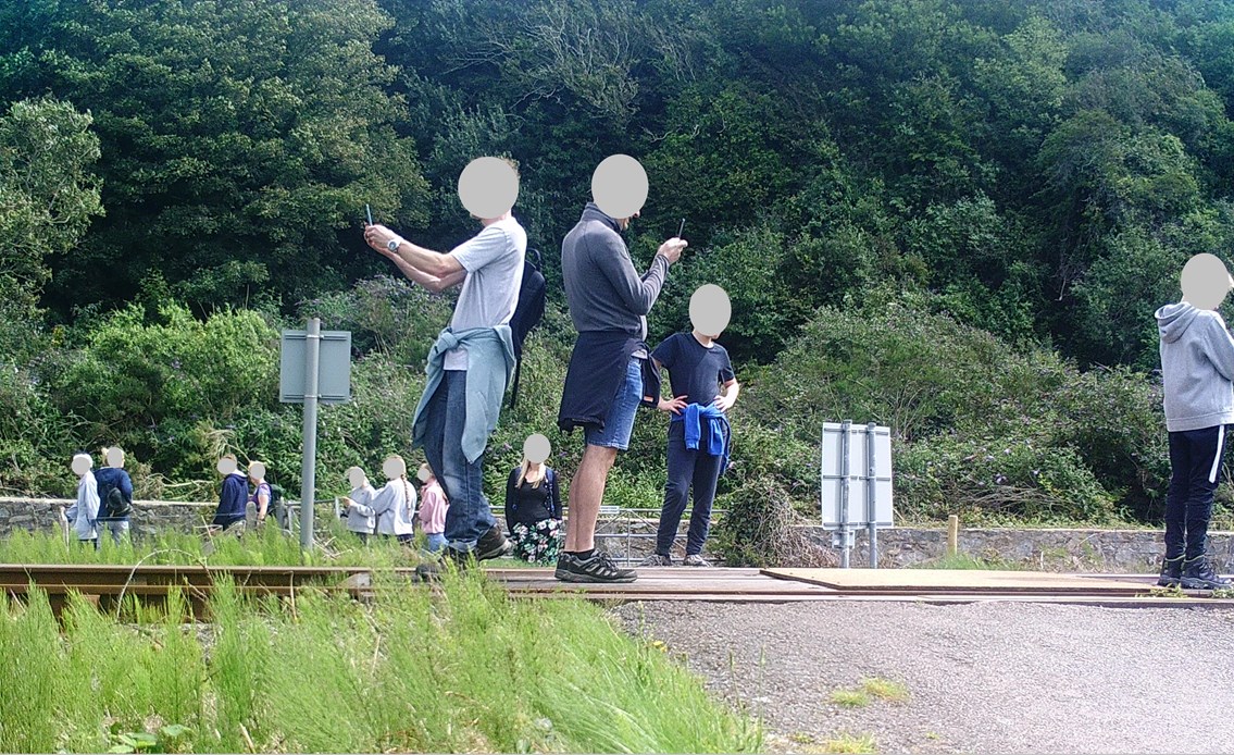 Several people stop on the track for a photo at Harlech