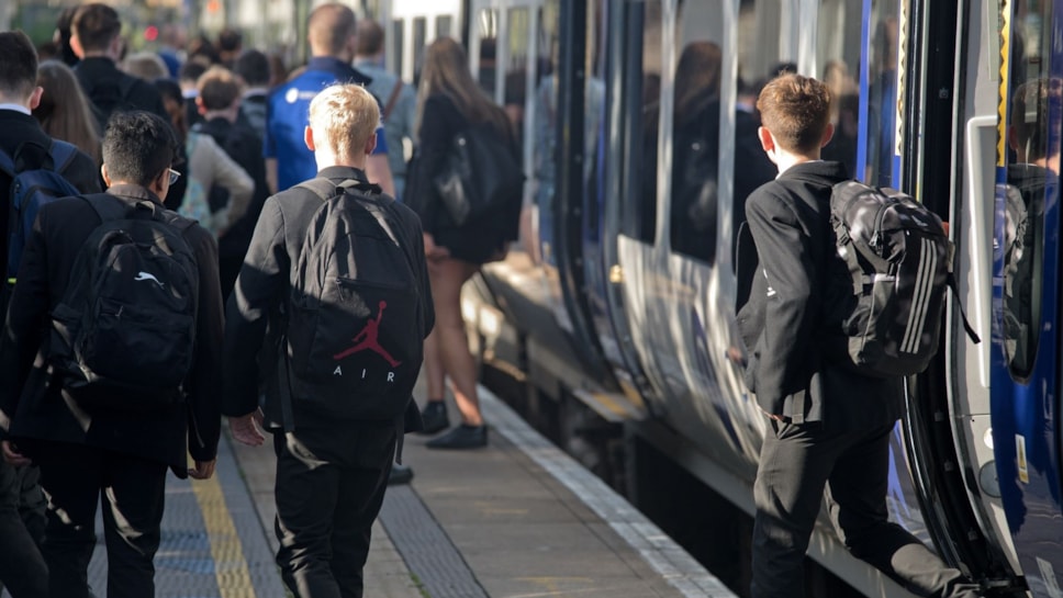 Image shows secondary school students commuting to school