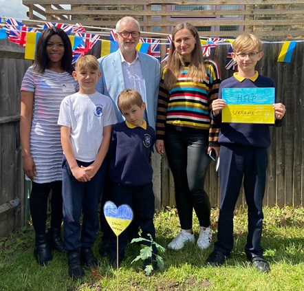 With the newly-planted oak sapling at Christ The King Catholic Primary School are, from left, Cllr Michelline Ngongo, Osap, Jeremy Corbyn MP, Nikita, Yulia and Denys-2
