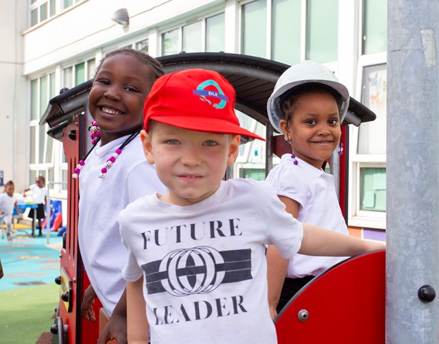 Deptford - train driving: Children enjoy their train in the playground at Grinling Gibbons school, Deptford