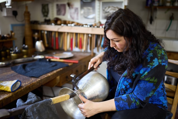 Reflections in Silver: Artist Miriam Handid has been crafting her Phoenix Jug piece in her Suffolk workshop after being inspired by the birds of Temple Newsam, in particular an 18th century side table designed by John Vardy and the Chinese Drawing Room wallpaper featuring birds cut from John James Audubon’s book The Birds of America. Credit Leeds Museums and Galleries Nick Singleton.