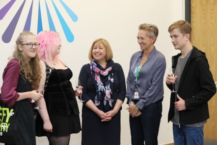 Lynne Neagle cabinet secretary for education and Coleg Cambria CEO Yana Williams congratulate successful students L-R: Catrin Roberts, Lauren Slawson and Dylan Ellis-Jones during a visit to the Yale campus, Wrexham