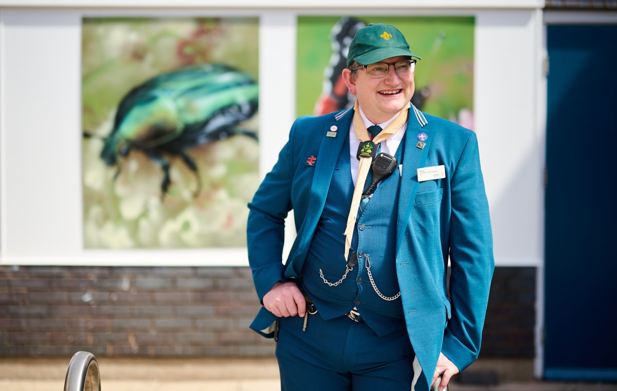 Justin Williams, Avanti West Coast, stands in front of Tom Edwards' artwork on the platform at Stafford station.