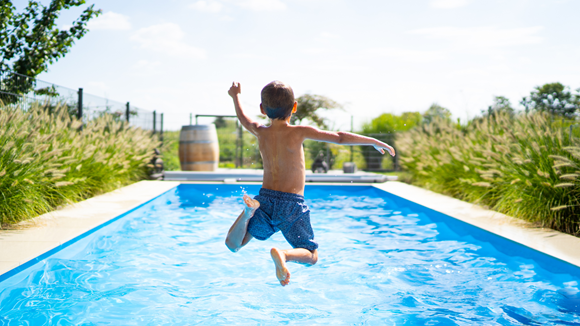 Sunshine Saturday set for record bookings as thousands more plan to jet off on holiday: Boy jumping in pool