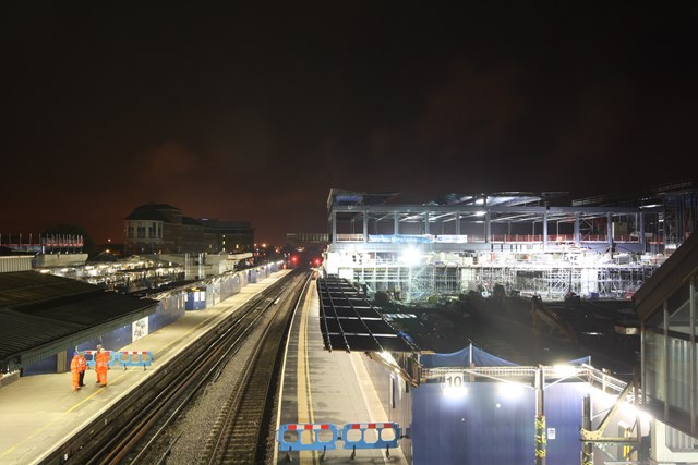 Reading station footbridge slides into place as night falls: Reading station footbridge slides into place across the railway as night falls