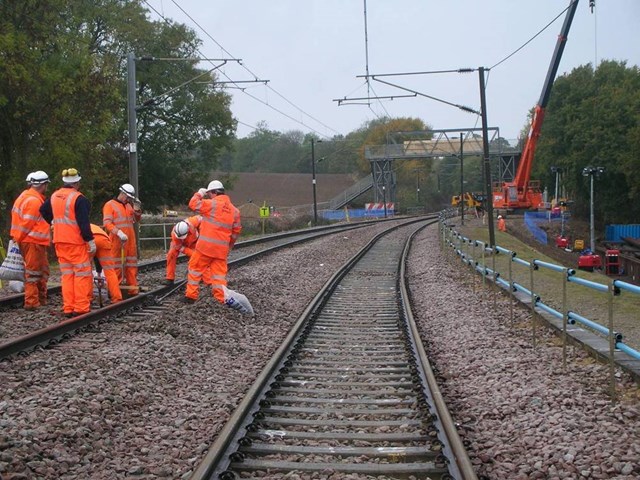 Copperas Wood embankment - track realignment: Following the installation of the metal sheet piling at the base of the railway embankment (right of picture) engineers realigned the track using tamping equipment and ballast.