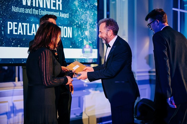 Peter Hutchinson, NatureScot Peatland ACTION Programme Strategy Manager, and Barry Dunne, NatureScot Peatland ACTION Head of Operations, receiving the Holyrood Climate Action Award for Nature and the Environment at the awards ceremony in Edinburgh. ©Andrew Perry.