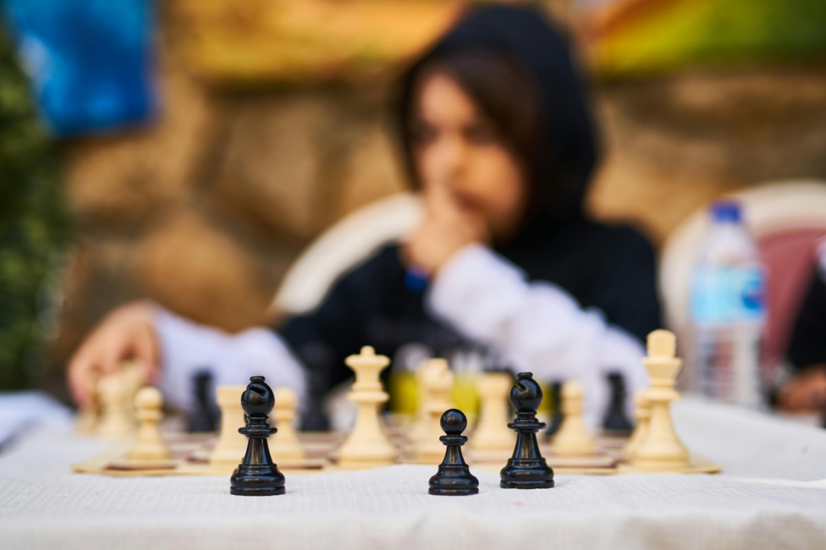 Girl playing chess outside
