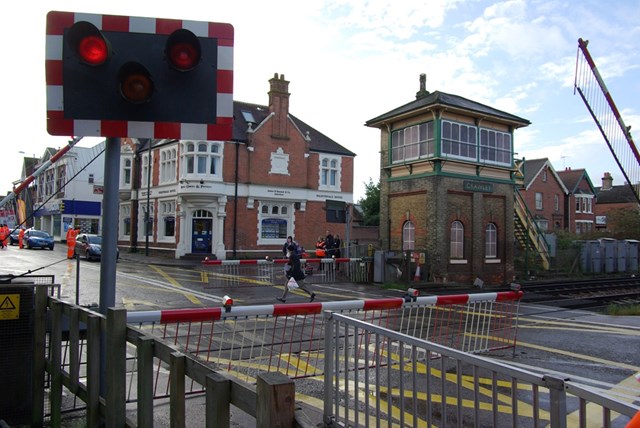 Man makes dash over crossing as barriers are lowered, Crawley High Street LX: Man makes dash over crossing as barriers are lowered, Crawley High Street LX