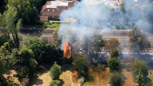 Heatwave damage means no direct trains between London and Scotland: Trees on fire beside West Coast main line in Harrow Greater London July 19 2022