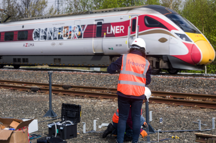 Treeva team installing turbines as LNER Azuma 'Century' passes