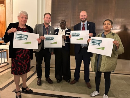 Councillors with Borough of Sanctuary signs