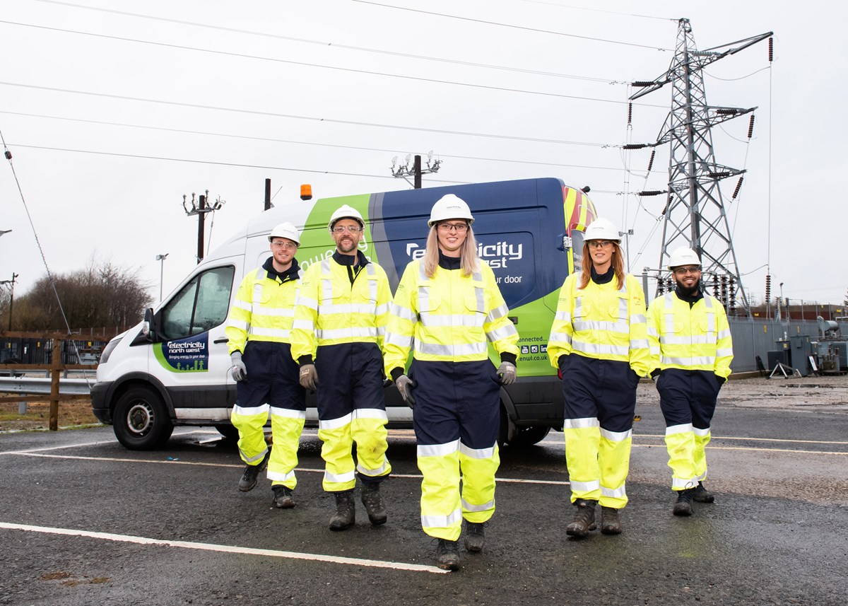ENWL apprentices beside electricity pylon: ENWL apprentices (Photo credit: Sara Porter Photography for Electricity North West)