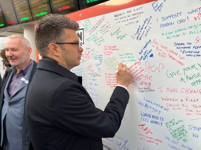 Jonny Wiseman, customer experience director for West Midlands Railway, signing the White Ribbon pledge wall: Jonny Wiseman, customer experience director for West Midlands Railway, signing the White Ribbon pledge wall