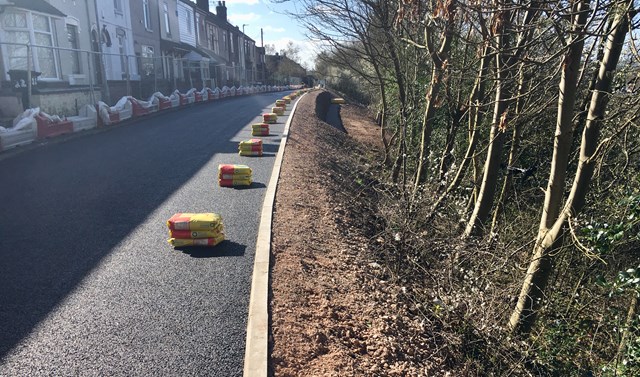 Next phase begins to secure moving residential street beside the West Coast main line: The secured earth at West Parade in Stoke-on-Trent in Spring 2019