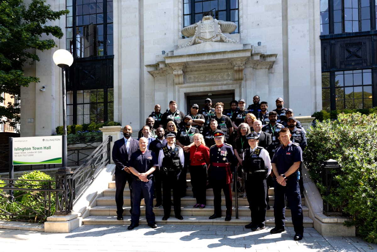 Islington's new neighbourhood patrol team stand in uniform on the steps on the town hall alongside, officers from Parkguard, Met Police, Kingdom and London Fire Brigade.