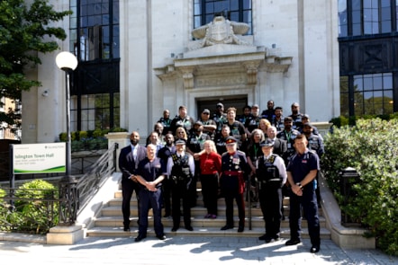 Islington's new neighbourhood patrol team stand in uniform on the steps on the town hall alongside, officers from Parkguard, Met Police, Kingdom and London Fire Brigade.