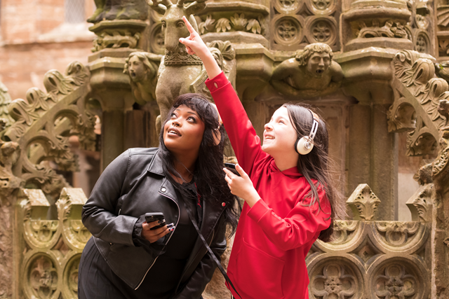 Linlithgow Scots Audio Guide: Laura Lovemore, a professional Scottish actor who provides the voice of Margaret More, one of the women known in the records as the ‘Moorish Lassies’, listening to the new Scots audio guide at Linlithgow Palace with Martha who voices the young Princess Elizabeth, daughter of James VI & Anna of Denmark.