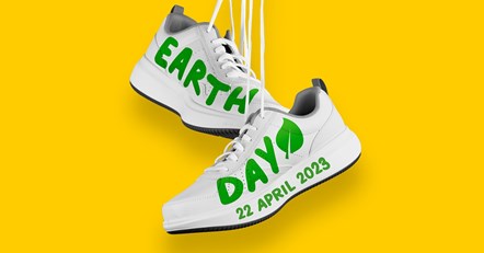 A graphic showing a pair of white trainers hanging from their laces, against a yellow background. The trainers have the words 'Earth Day, 22 April 2023' written on them.