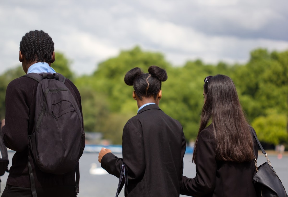 three young people in school uniforms