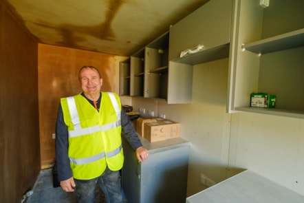 Cllr McMahon viewing new kitchen being fitted in Barshare